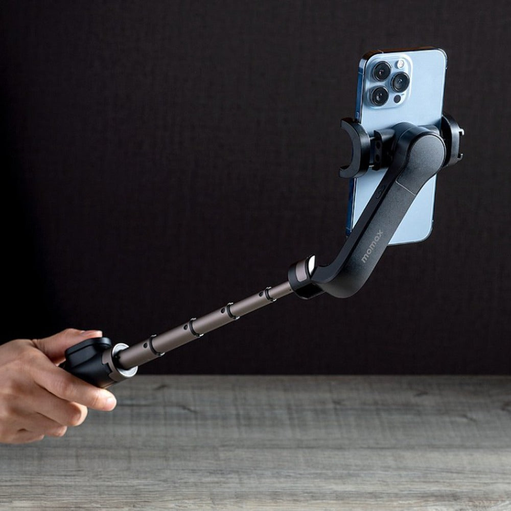 someone holding Momax One Click Rotation Selfie Stable