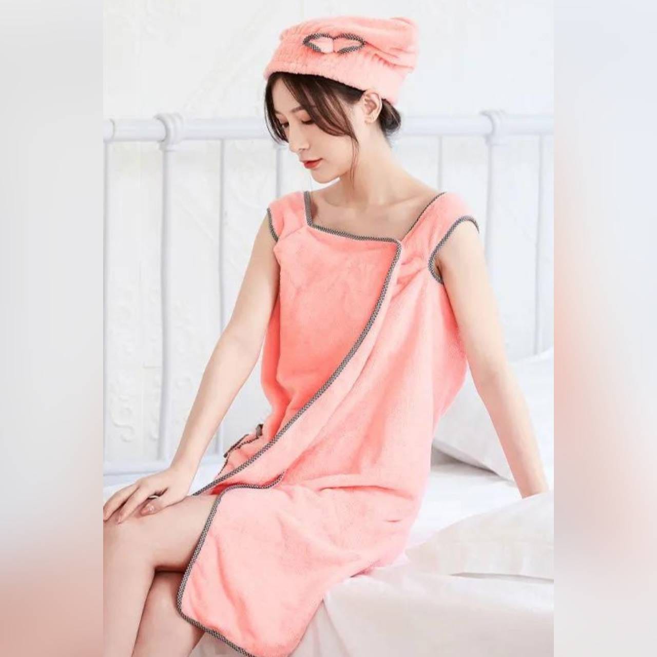 A lady wearing a soft thick microfiber bath towel in pink color