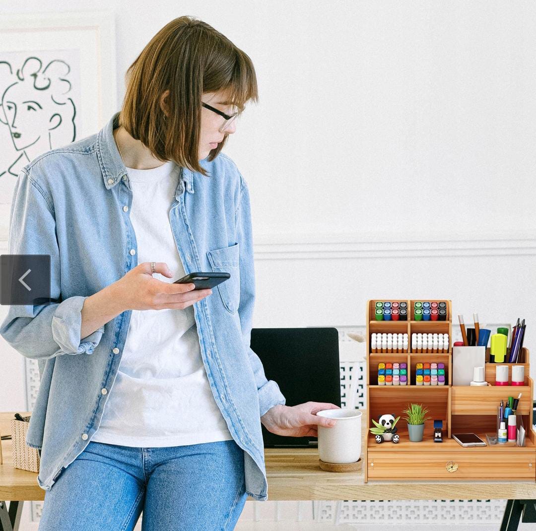 A Women Stand Beside a Desk Holder with Multipurpose Drawer.