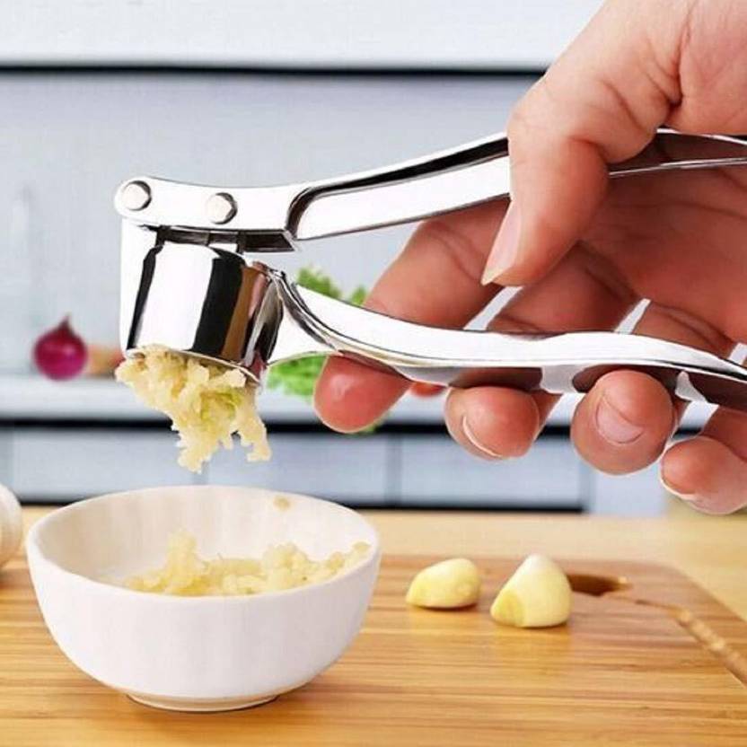 A Person is Crushing Garlic Using Manual Lemon Squeezer & Stainless Steel Ginger Garlic Press.