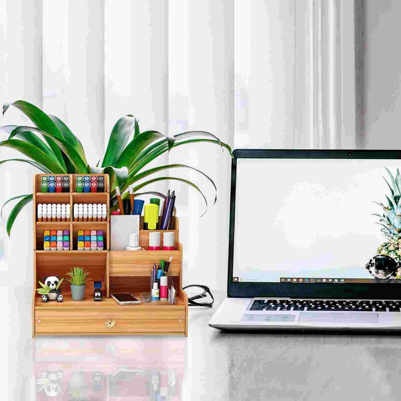 A Wooden Stand Organizer is Kept Beside on the Laptop.
