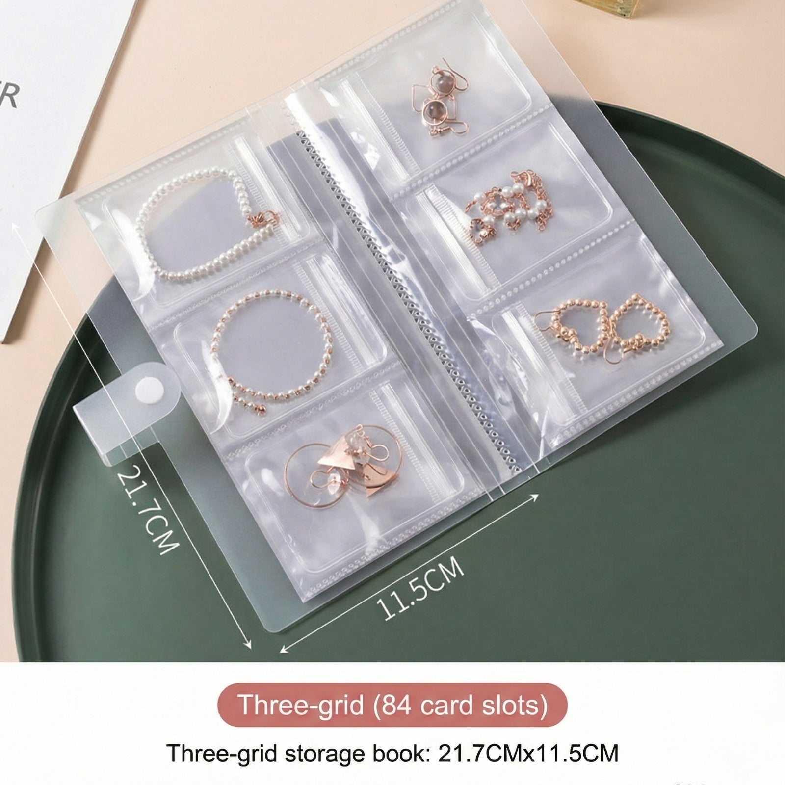 A transparent jewelry storage book with multiple clear pocket sleeves displaying neatly organized earrings, bracelets, and rings.