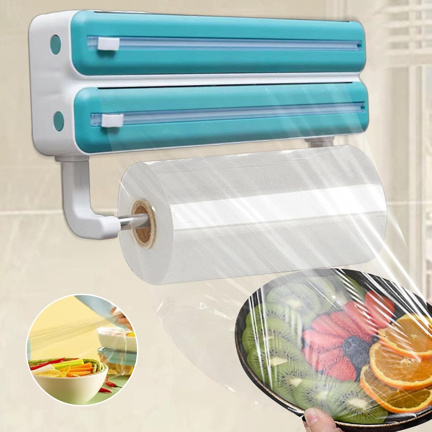 A wall-mounted triple paper dispenser with built-in cutters for cling film and foil, plus a paper towel holder below. It shows cling film being pulled to cover a plate, highlighting easy food storage and kitchen organization.