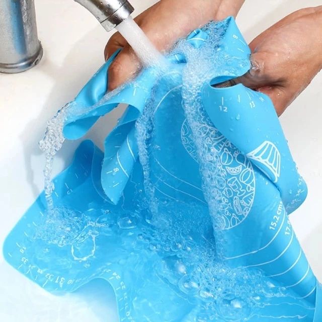 Someone cleaning a Non-stick Silicone Dough Mat