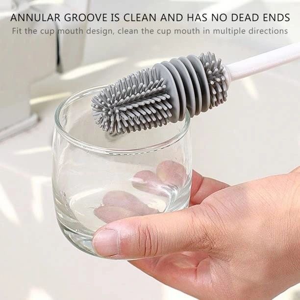 Someone cleaning glass with the help of a Silicone Corner Brush for bottles