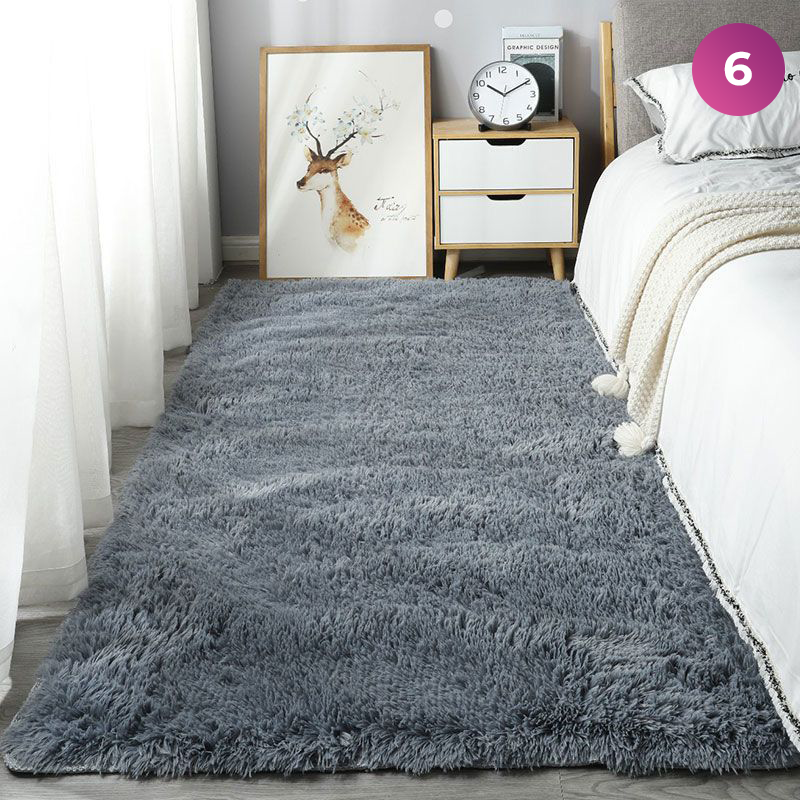 An Ultra Soft Indoor Rug is placed in a room next to the bed