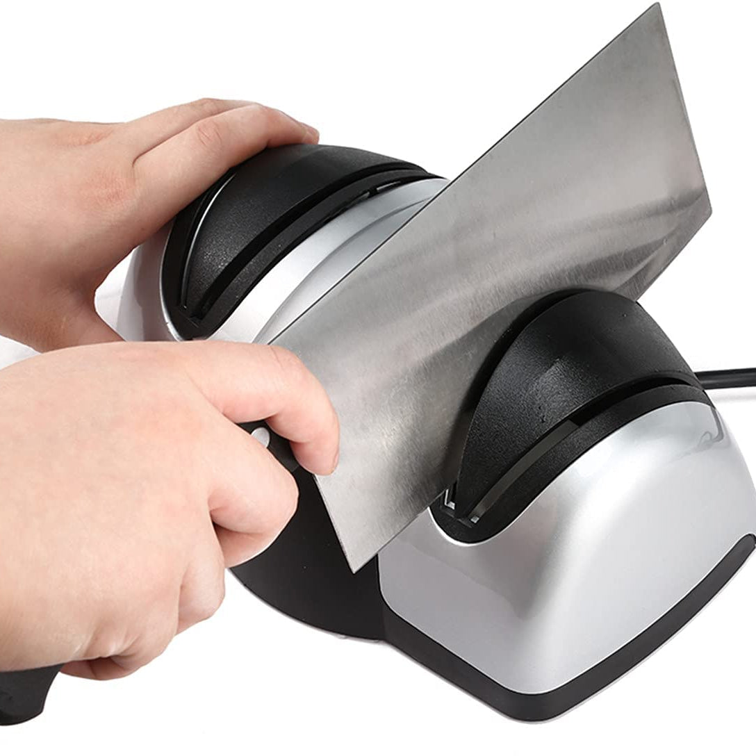 Someone sharpening a knife with the help of a Professional Kitchen Electric Knife Sharpener
