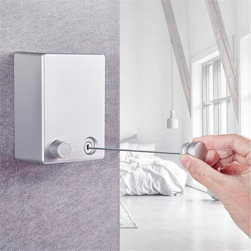 a hand holding a Retractable Wire Indoor and Outdoor Clothes Wall Hanger