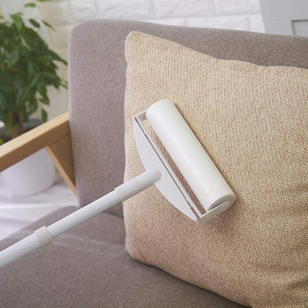 Someone rolling Sticky Mop with Sticky Paper Roller, 60 Sheets, on the pillow