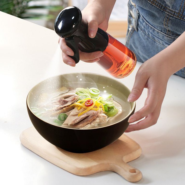Someone is using a 200ml Kitchen Cooking Salad BBQ Oil Sprayer