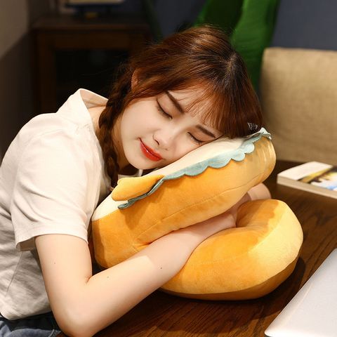 A girl is sleeping while sitting with the help of a washable comfortable cute neck pillow