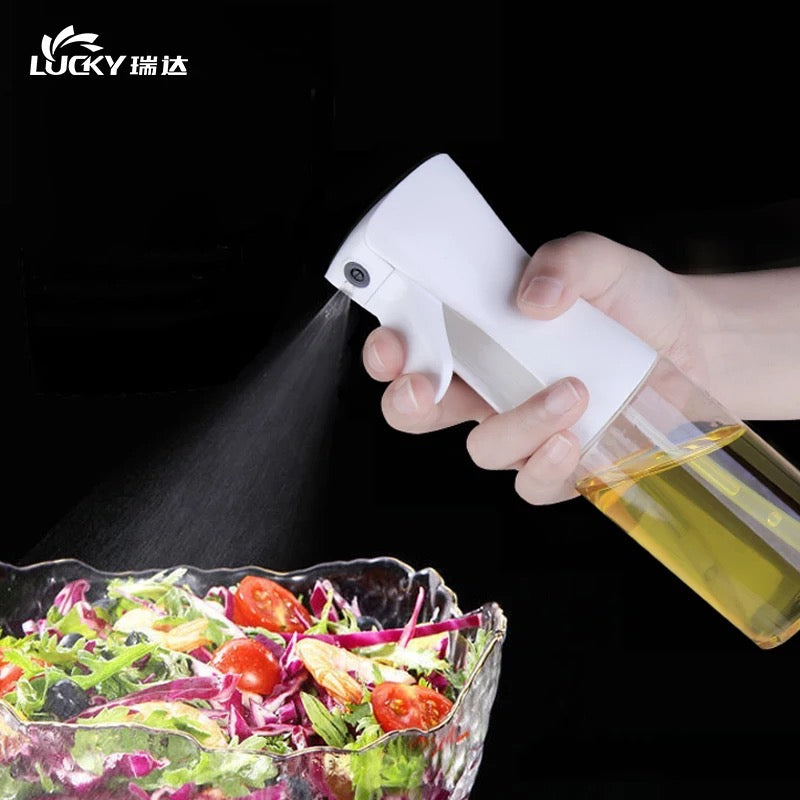 Someone is using a 200ml Kitchen Cooking Salad BBQ Oil Sprayer on food