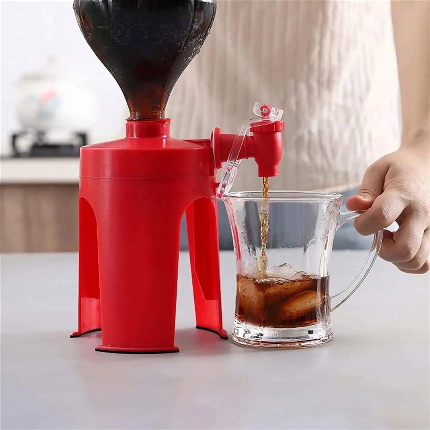 A person utilizes the Inverted Easy Soda & Cool Drinks Dispenser to pour a beverage