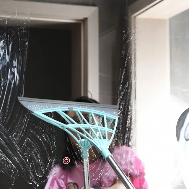 Someone cleaning glass with Multifunction Magic Broom with Adjustable Length