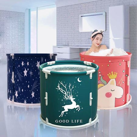 A woman peacefully sits in a bathtub.