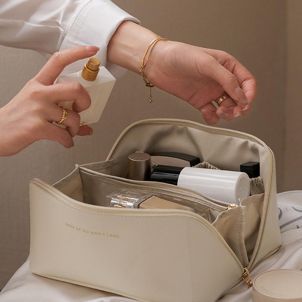 a lady taking perfume from Large Capacity Foldable Travel Cosmetic Bag