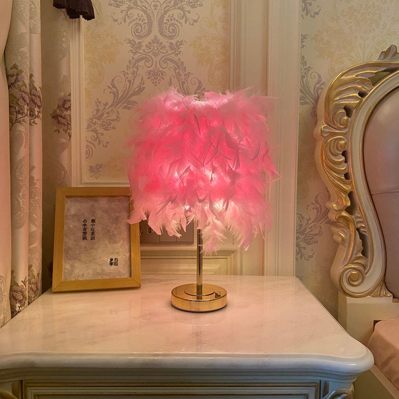 A Feather Shade Table Lamp is placed on the table next to the sofa