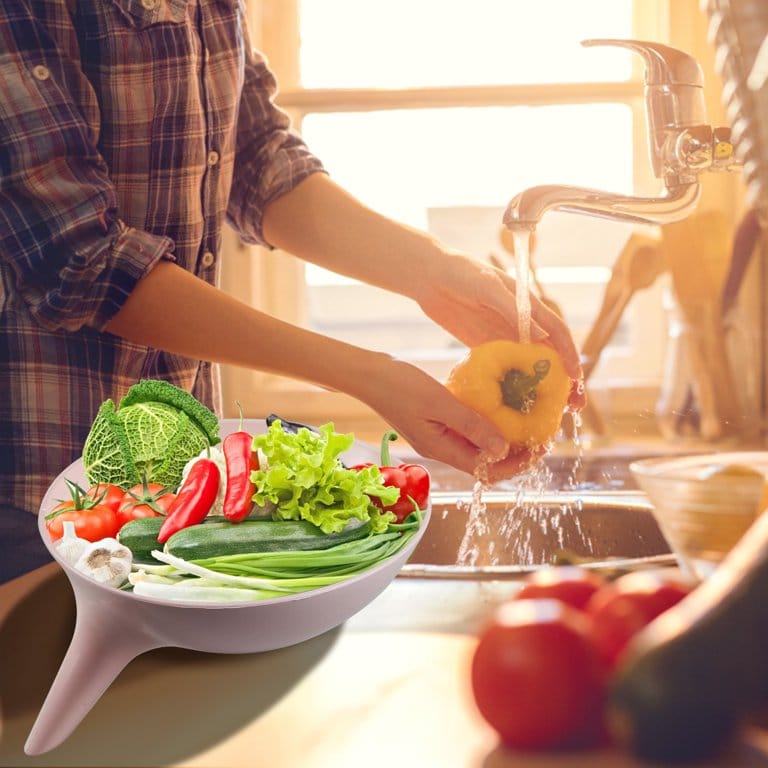 Someone putting washed vegetables into a Multifunctional Kitchen Drain Bowl