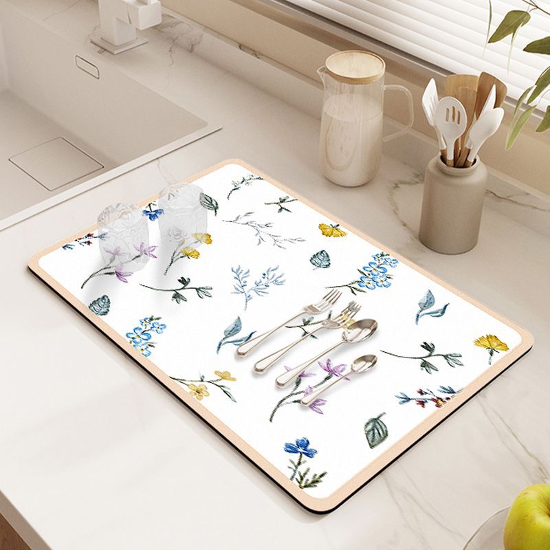 Showcasing Dish Drying Mat with spoons,forks and two glass cups kept on a kitchen counter top near to a sink