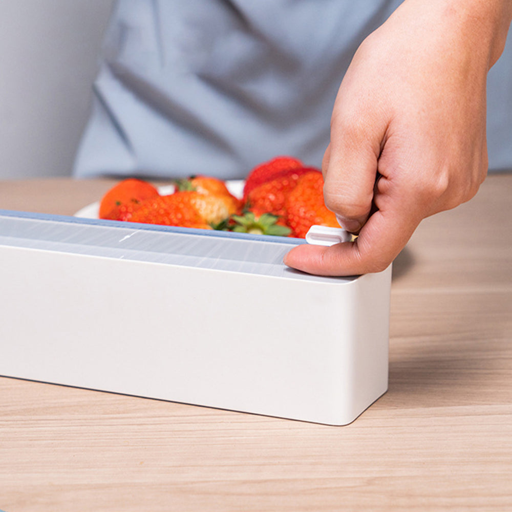 A person is touching his hand to the Wall Mount Instant Plastic Wrap Dispenser with Slide Cutter