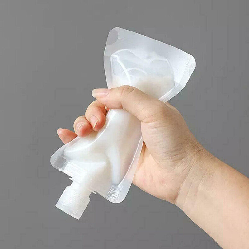 A hand holding a plastic Reusable Shampoo Lotion Liquid Dispenser Bags
