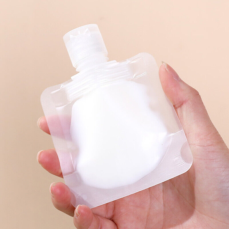 A hand holding a plastic Reusable Shampoo Lotion Liquid Dispenser Bags