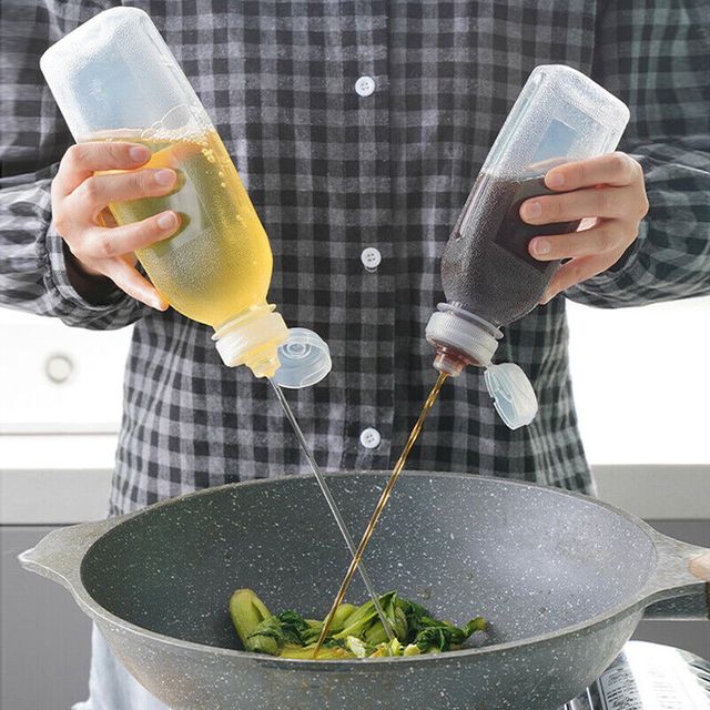 Someone is using a Kitchen Oil Spray Injection Press Bottle Sprayer Dispenser