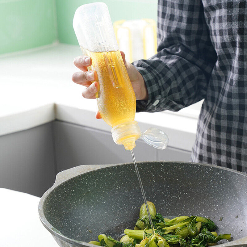 Someone is using a Kitchen Oil Spray Injection Press Bottle Sprayer Dispenser