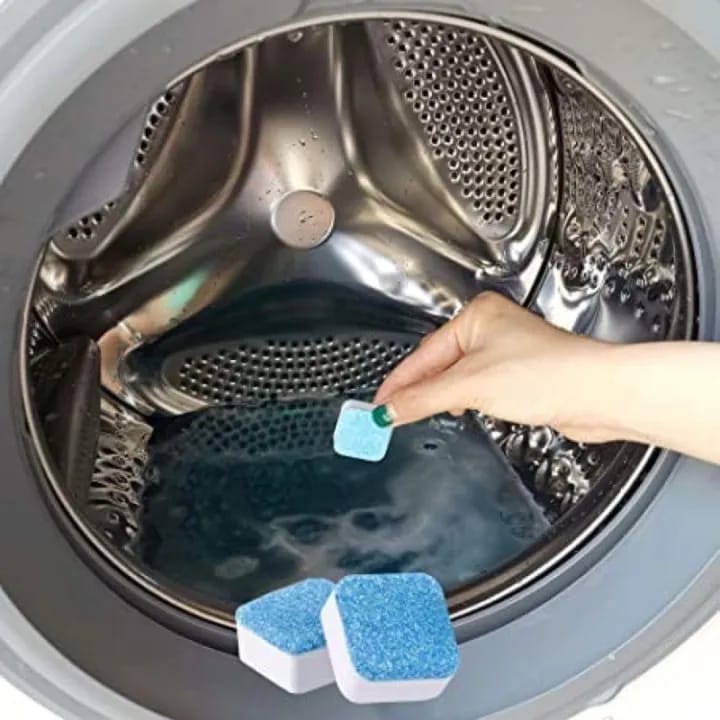 Someone holding a Washing Machine Cleaning Tablet