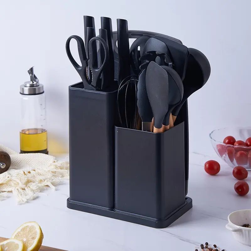 18-piece silicone kitchenware set in a  holder including spatulas, ladle, tongs, whisk, pasta server, brushes, and scissors, neatly organized on a kitchen countertop.