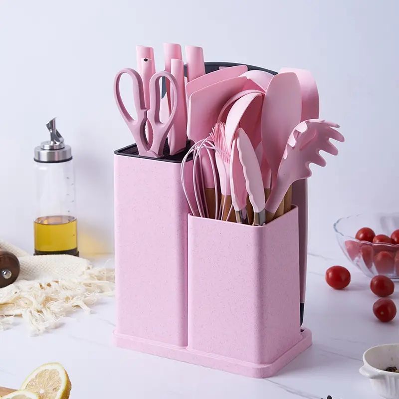 18-piece silicone kitchenware set in a  holder including spatulas, ladle, tongs, whisk, pasta server, brushes, and scissors, neatly organized on a kitchen countertop.