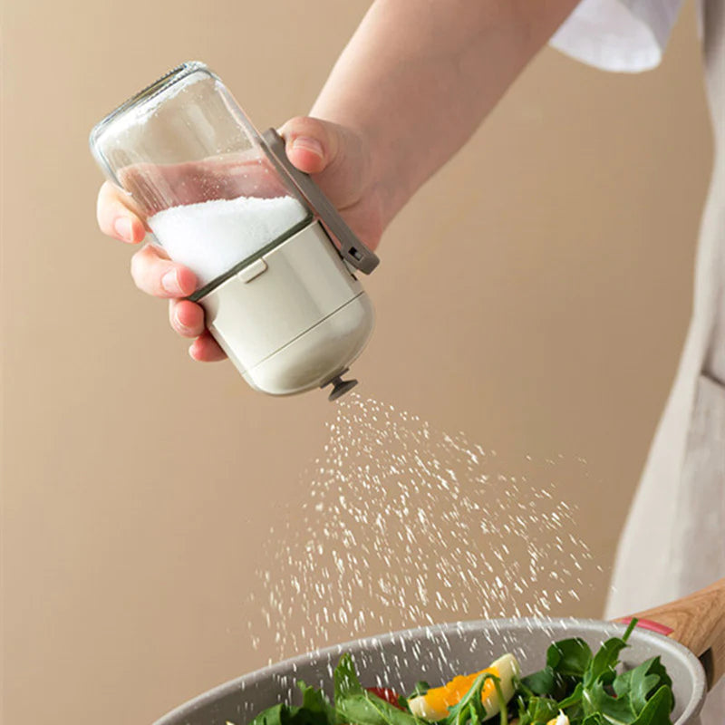 Someone putting salt from a 220ml Controlled Moisture-Proof Seasoning Bottle into food