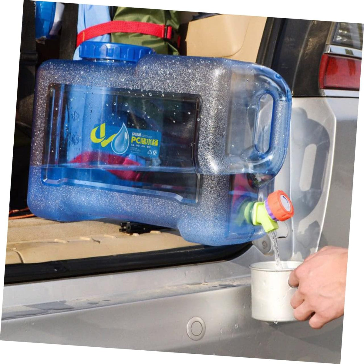 Someone is taking water from a 25L Portable Water Dispenser Container for the refrigerator