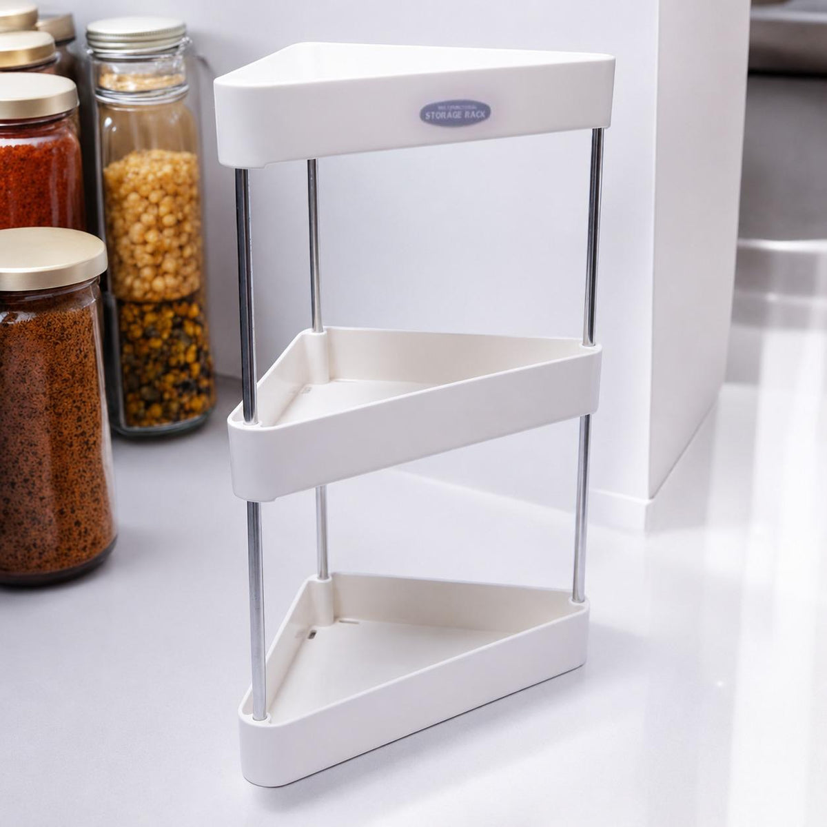 Corner kitchen storage rack with jars of spices on a white countertop
