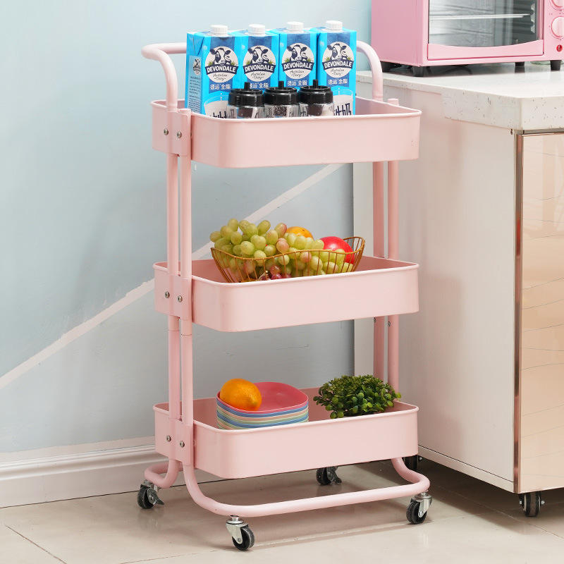 Pink three-tier rolling cart with groceries in a kitchen setting