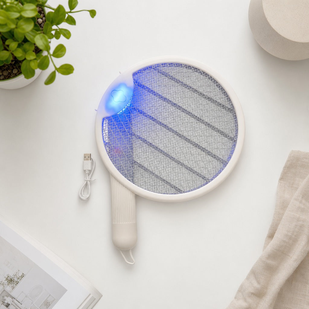 Electric fly swatter with blue light on a white surface