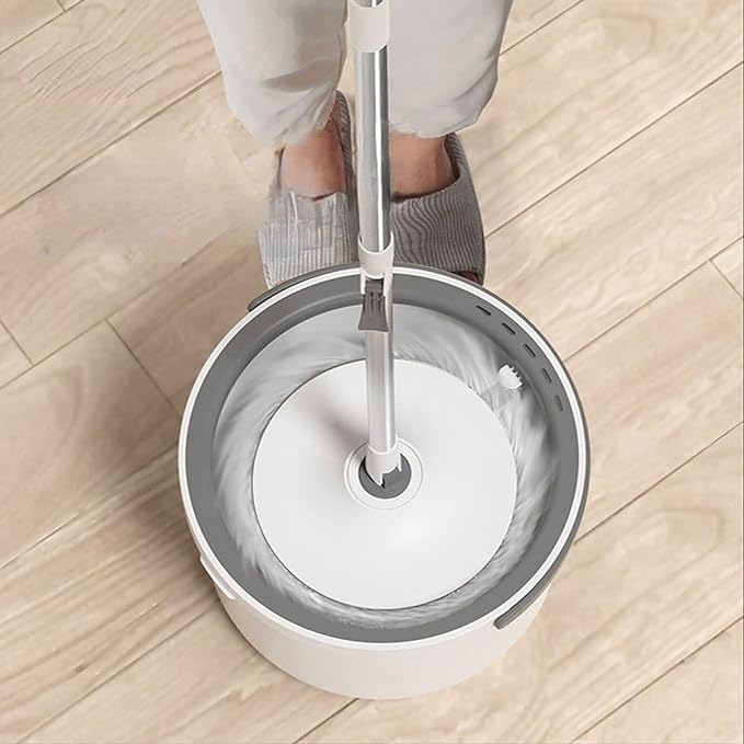 A girl is trying to clean a 360° Spin Mop and Bucket Set