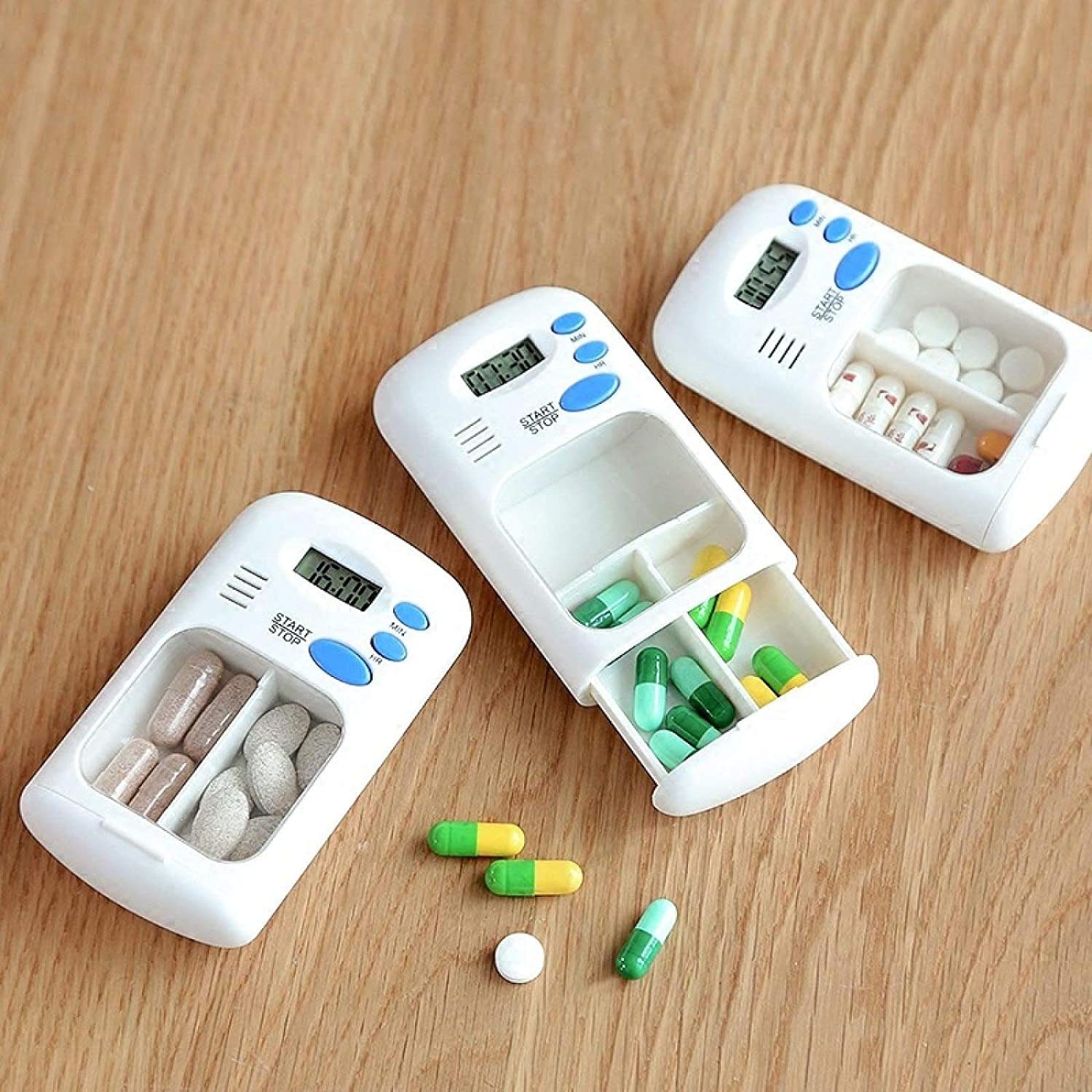 The Portable Mini Travel Carry Pill Box is placed on the table next to some pills