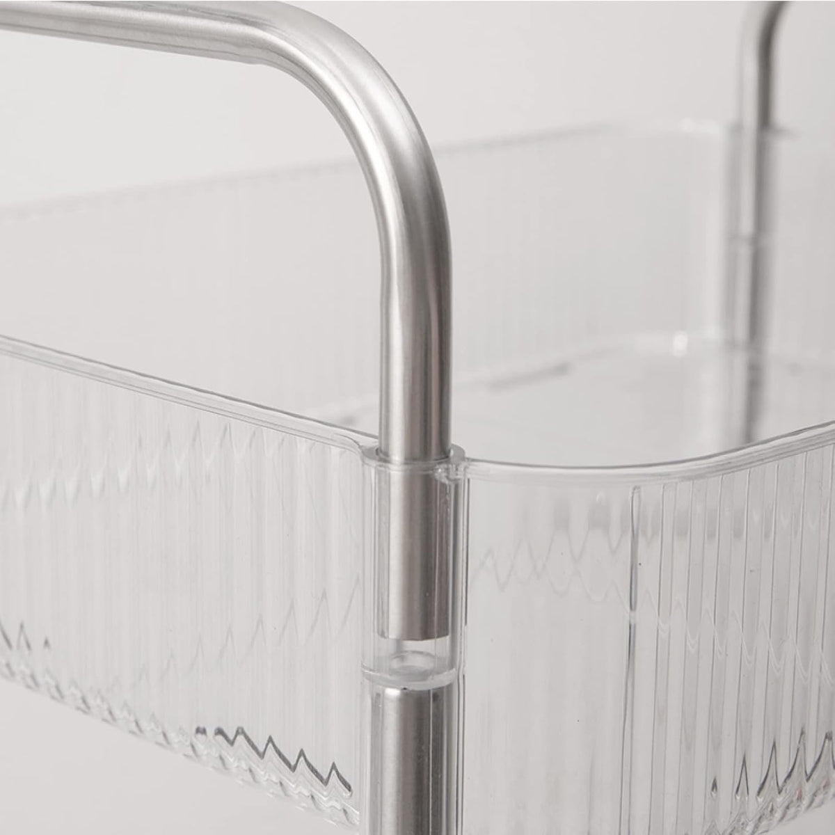 Clear acrylic basket of 4-Tier Rolling Storage Cart with metal handle on a light gray background