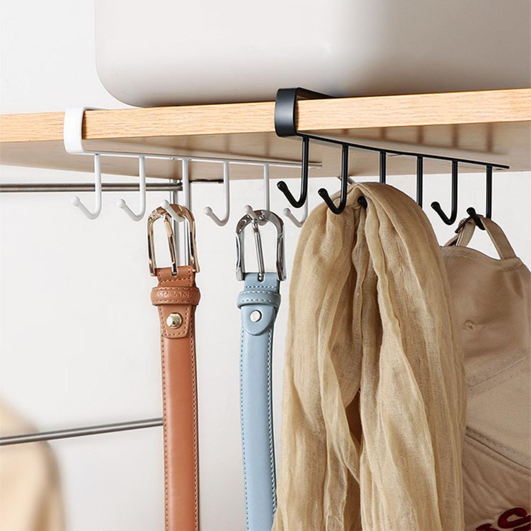 A metal organizer hanger with six hooks holding multiple belts on a rack