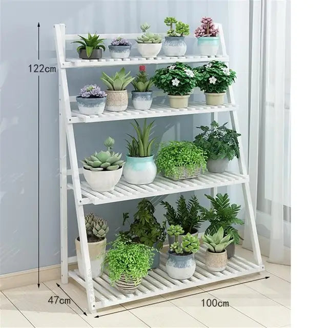  The white 4-Layer Foldable Indoor Wooden Plant Stand is elegantly arranged with various plants with its size