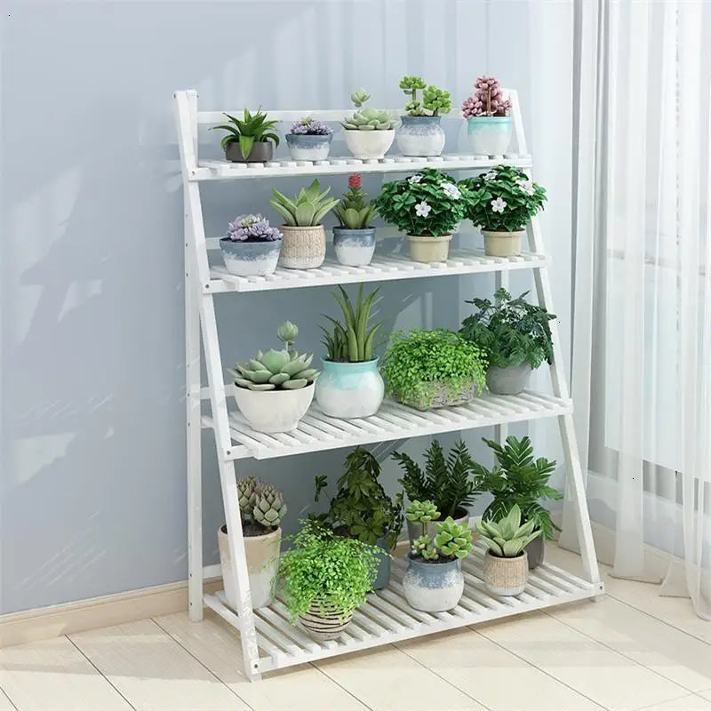 The white 4-Layer Foldable Indoor Wooden Plant Stand is elegantly arranged with various plants
