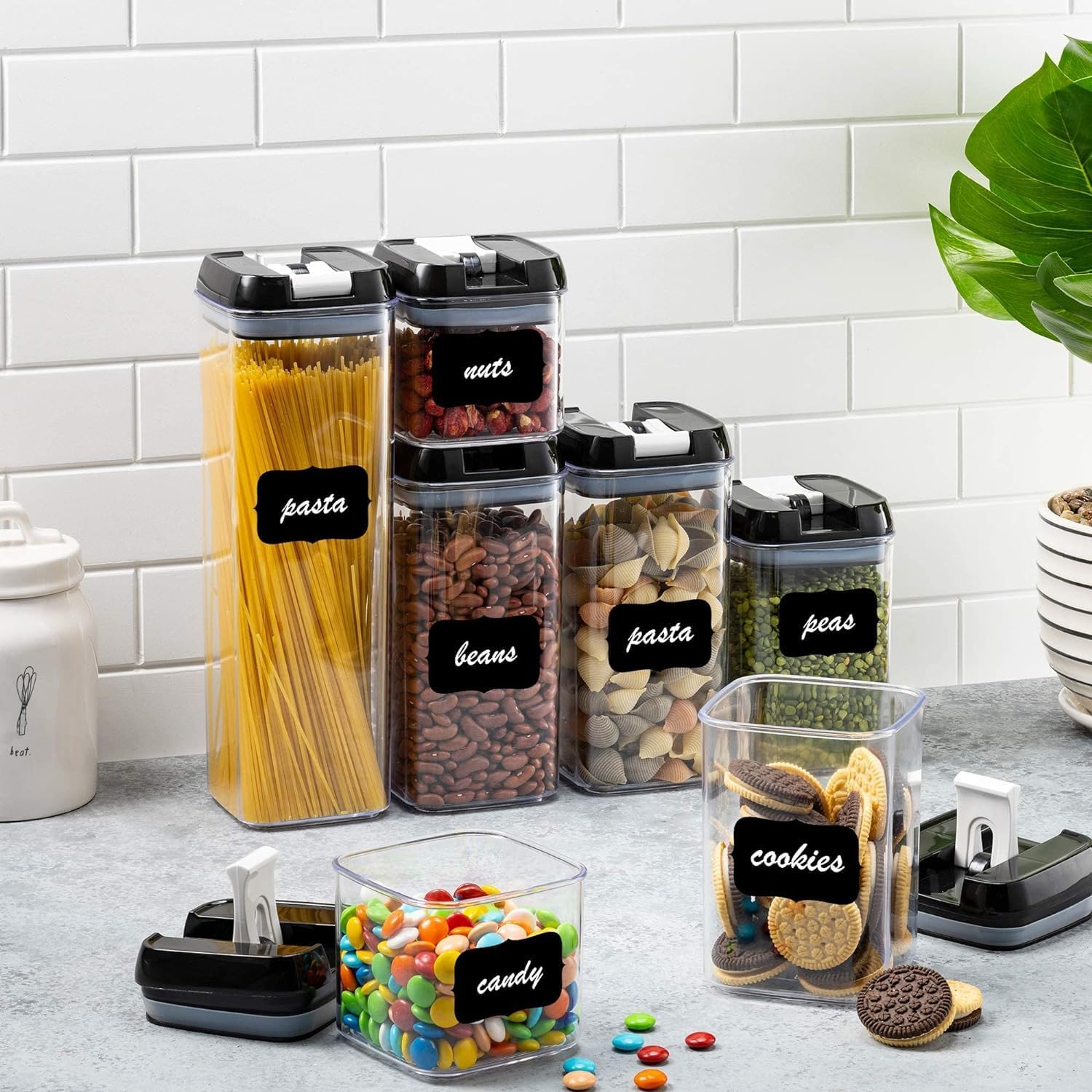 Set of 5-Piece Airtight Food Storage Containers Set with black lids and labels on a kitchen counter.