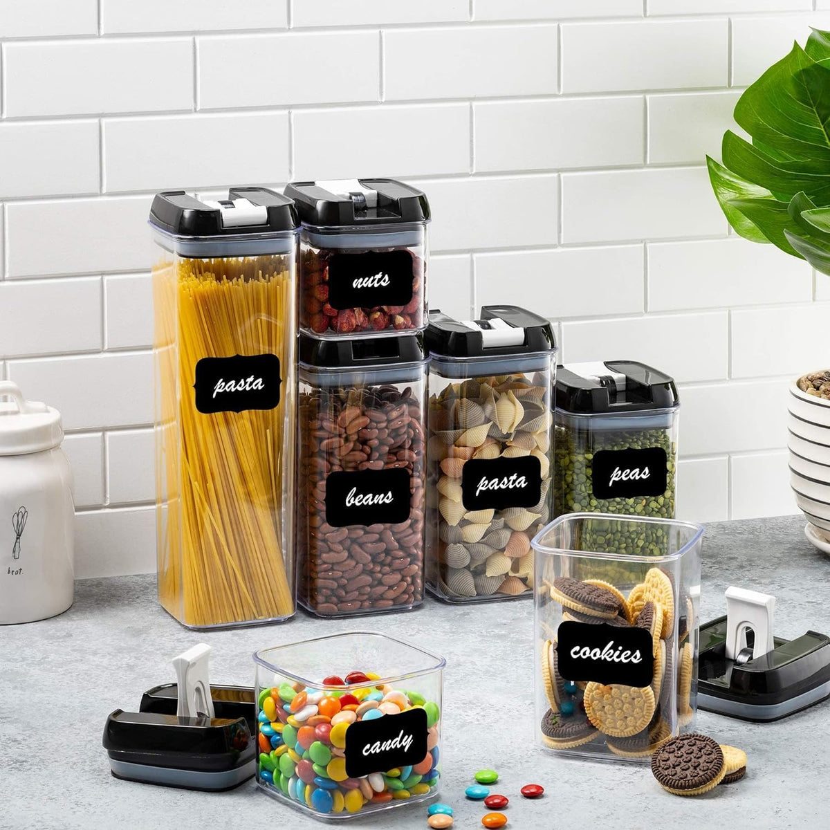 Set of 5-Piece Airtight Food Storage Containers Set with black lids and labels on a kitchen counter.