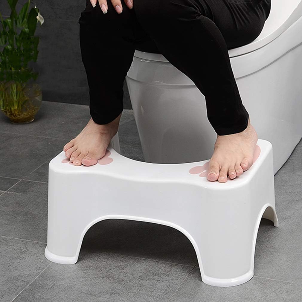 A person sitting on a toilet withe use of squat stool
