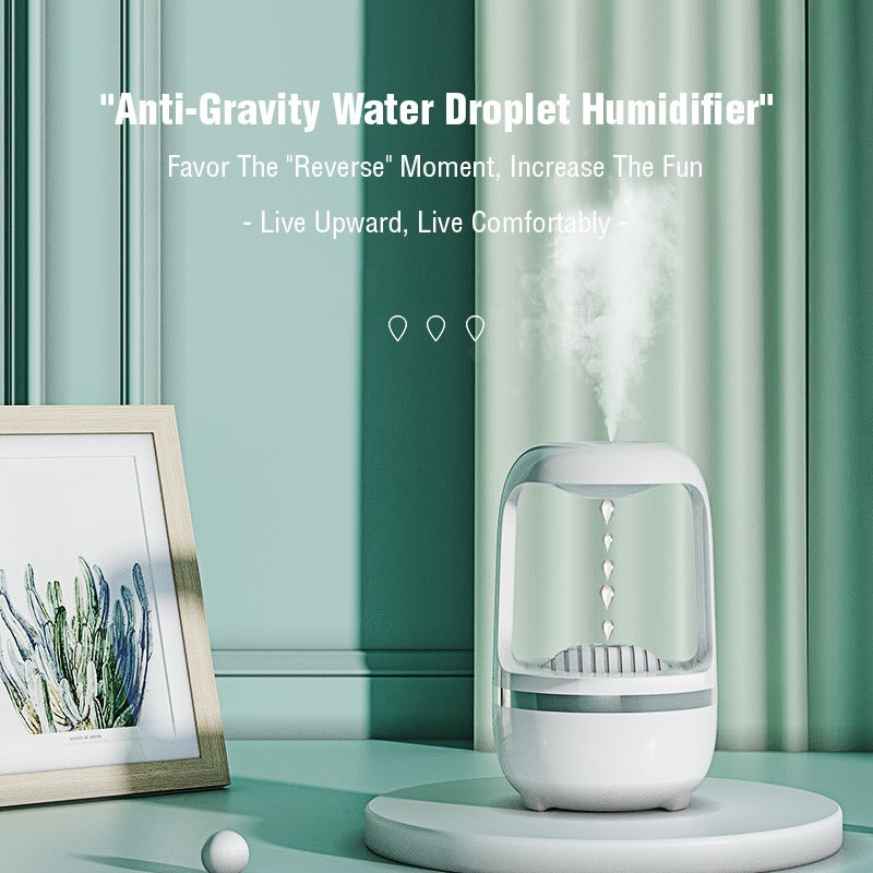 On a table, a white portable water dispenser known as the Anti-Gravity Water Drop Humidifier