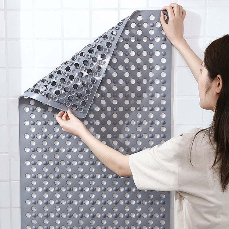 Someone holding a non-slip extra-long bathroom shower mat