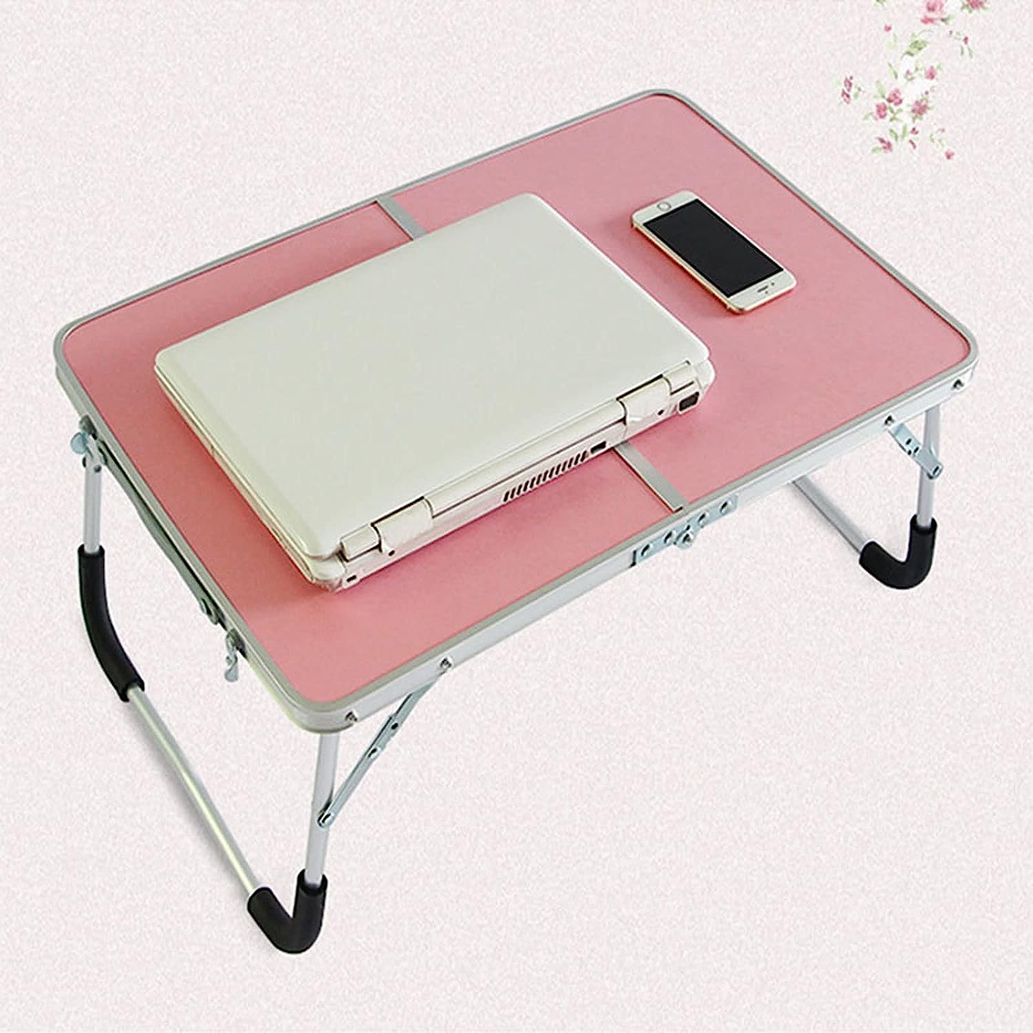 The laptop and phone are placed on the portable folding mini table