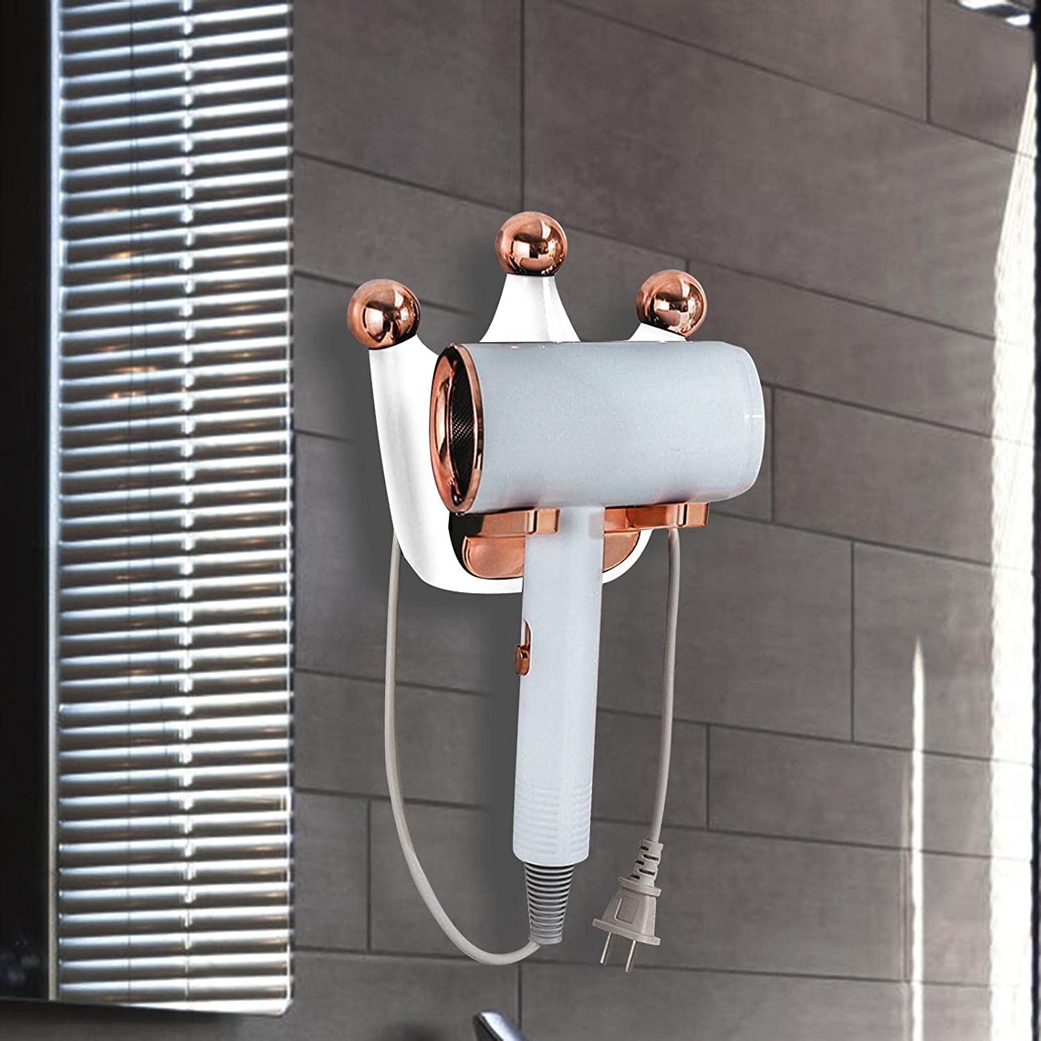 A wall-mounted hair dryer holder with a white hair dryer attached