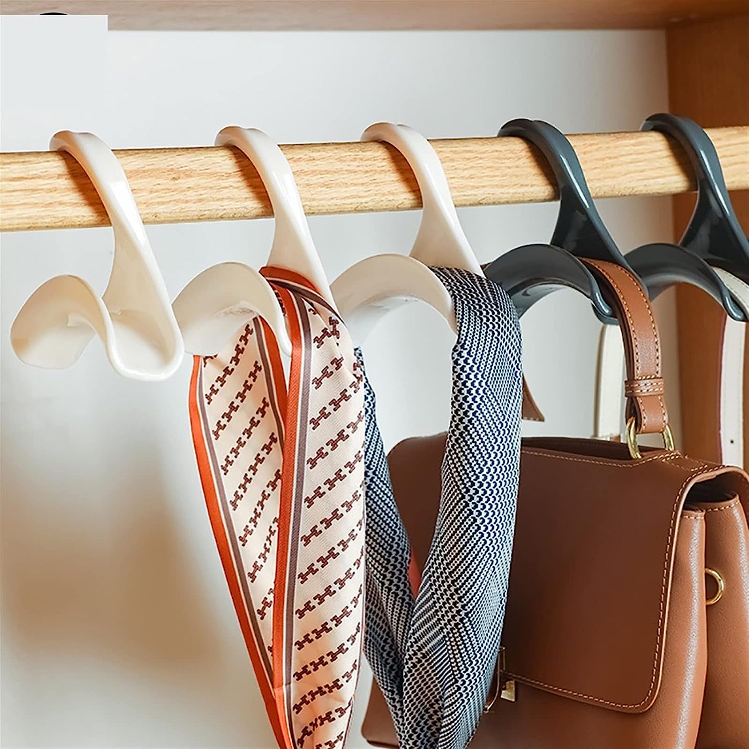 Efficiently organized rack showcasing various bags hung on specialized hanger hooks, ideal for saving space while organizing bags, belts, and scarves